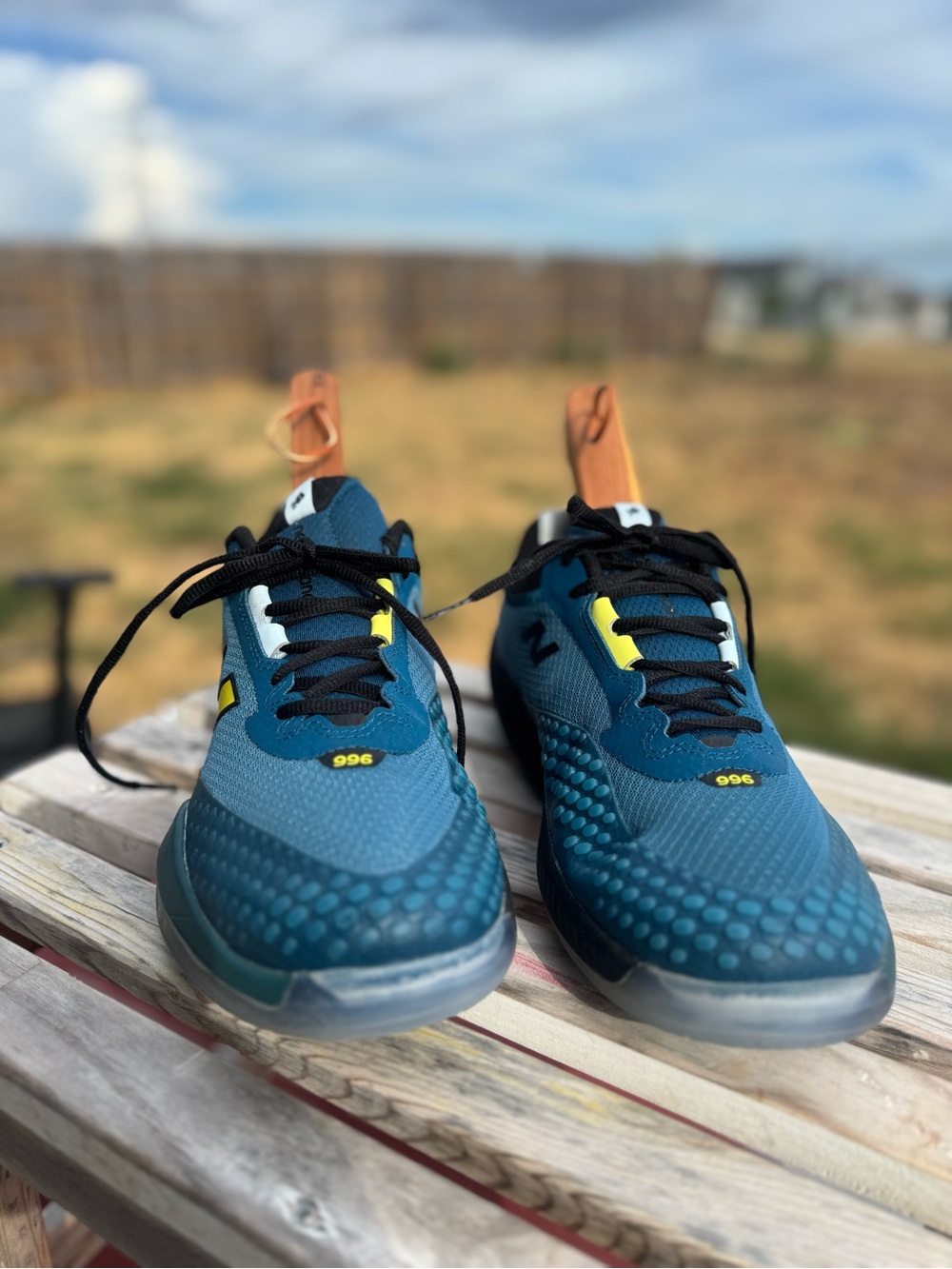 New Balance Teal Athletic Sneakers with Black Laces and Yellow Accents